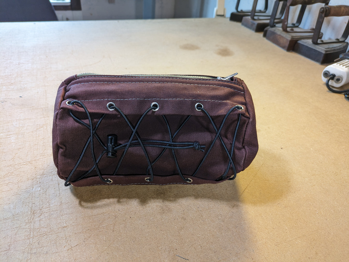 Burgundy steering bag with green strap and flexcord