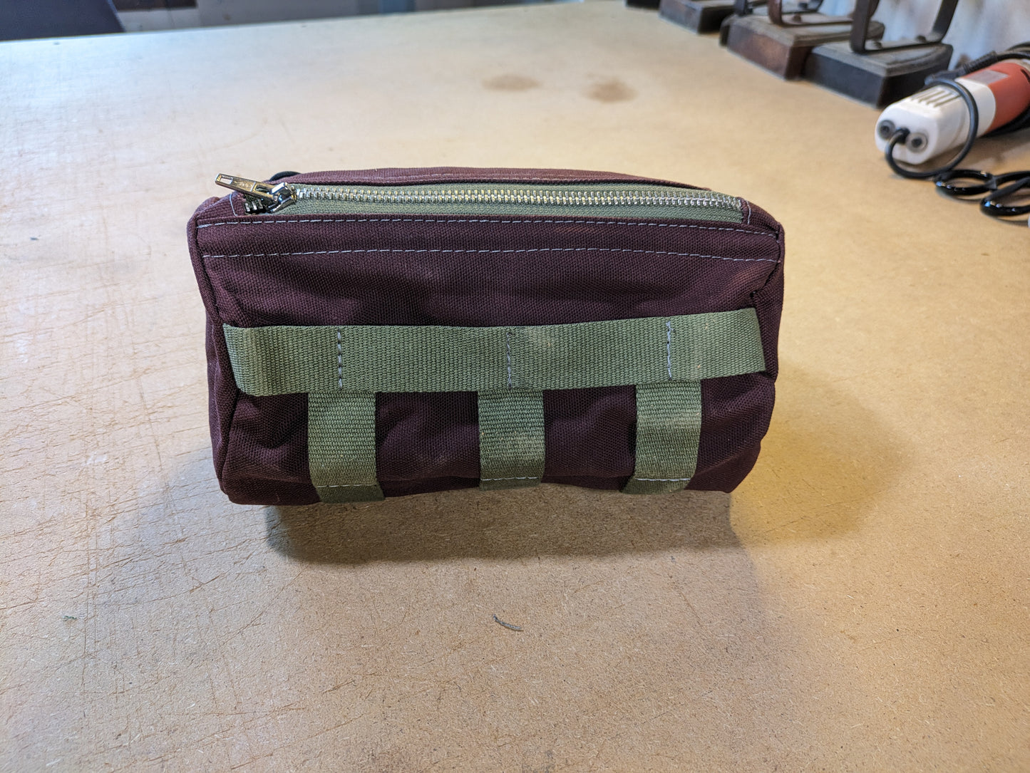 Burgundy steering bag with green strap and flexcord