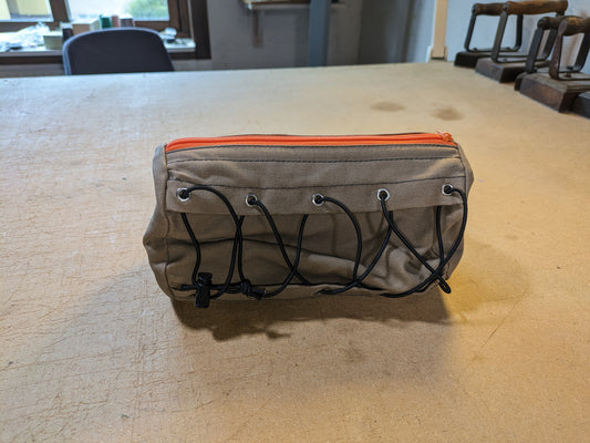 Drab/Khaki handlebar bag with black webbing, orange zipper and flexcord