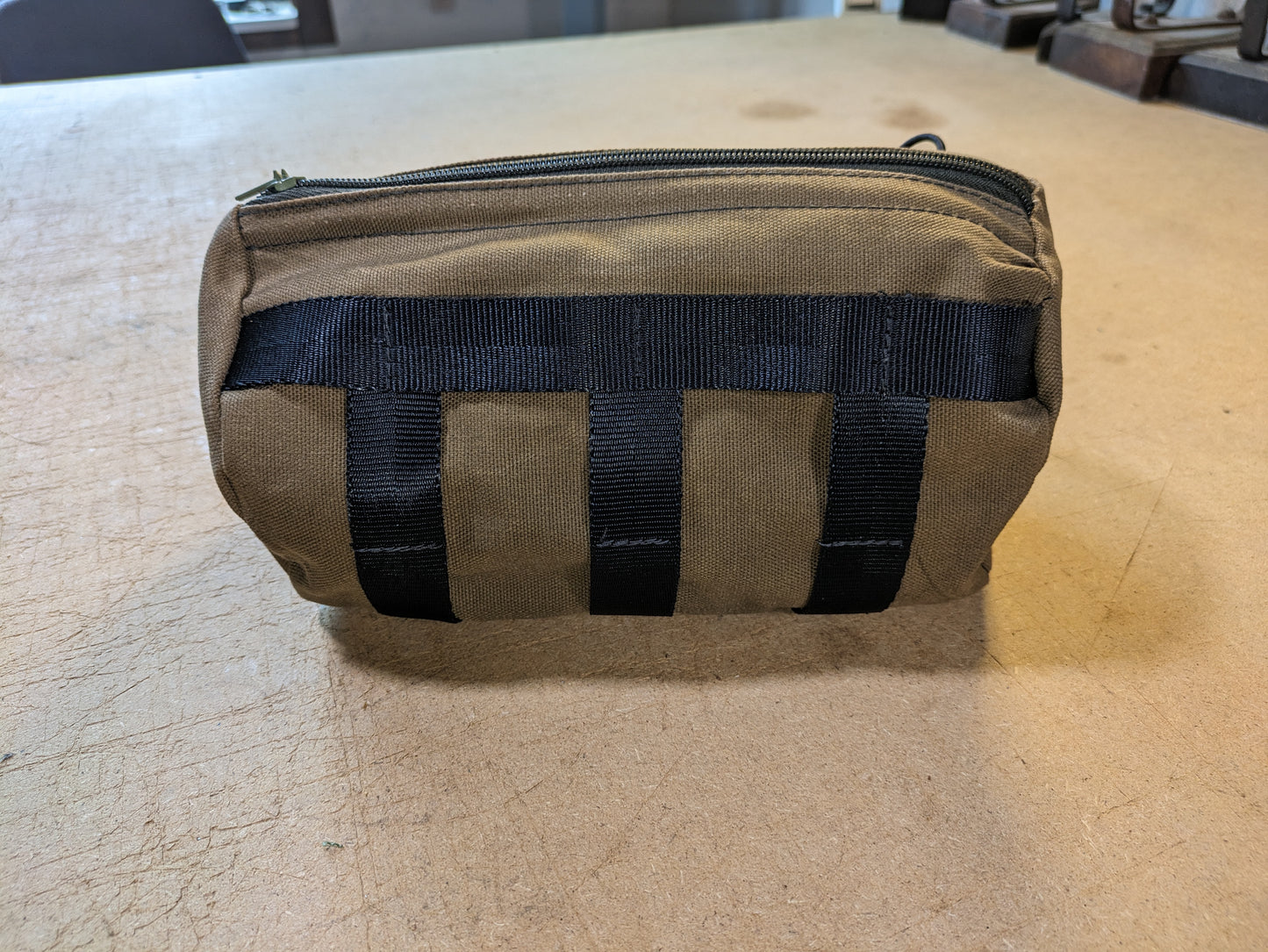 Drab/Khaki handlebar bag with black webbing, green zipper and flexcord