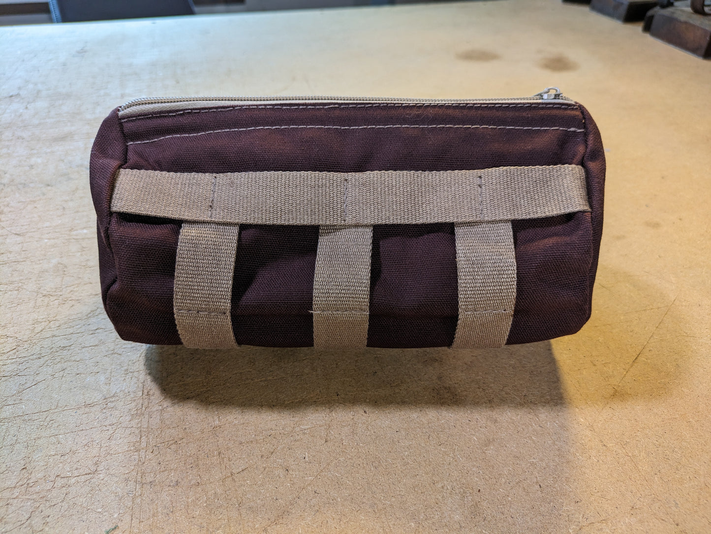 Burgundy handlebar bag with beige webbing and flexcord